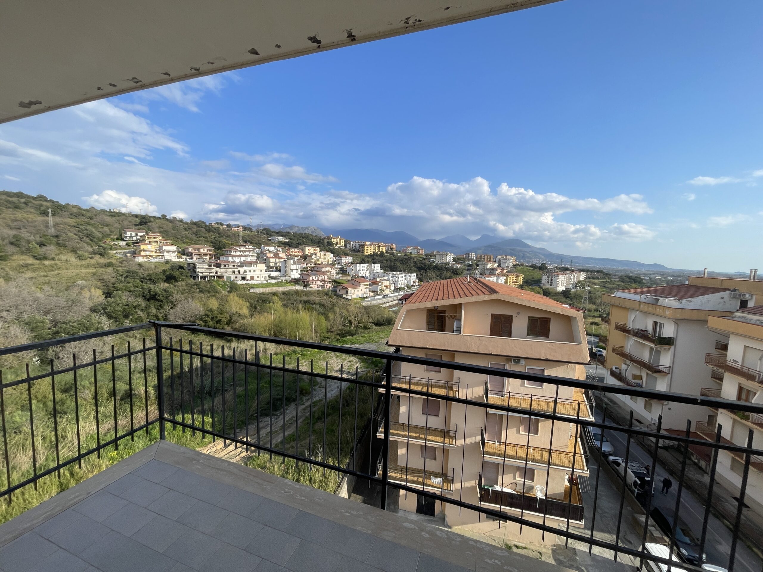 A flat with large panoramic balcony.